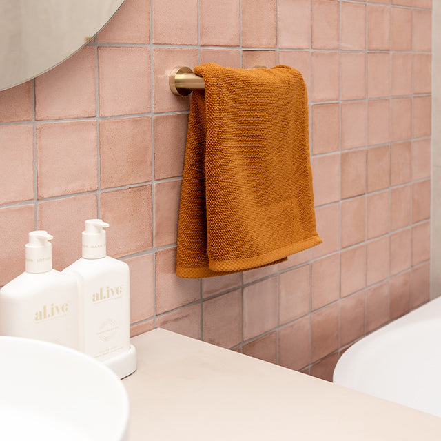 Nero Mecca brushed gold hand towel rail, Pink Dianna Tiles | Cam and Jules Bathroom collaboration with The Blue Space