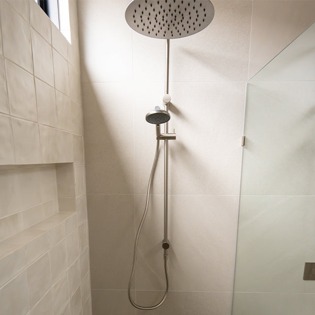 Caroma Liano brushed nickel taps, accessories, shower and Urbane II Cleanflush toilet suite | Timberline shaving cabinet | Modern Bathroom Renovation | The Blue Space