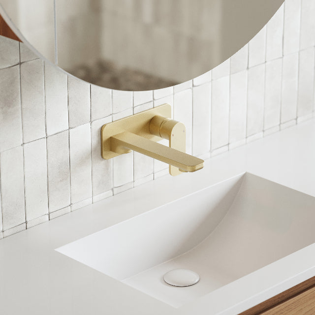 Caroma Luna Lead Free Wall Basin/Bath Mixer Brushed Brass on white textured feature tile