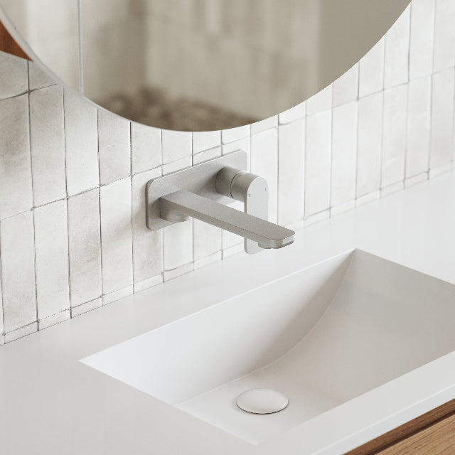 Caroma Luna Lead Free Wall Basin/Bath Mixer Brushed Nickel on white textured subway tile