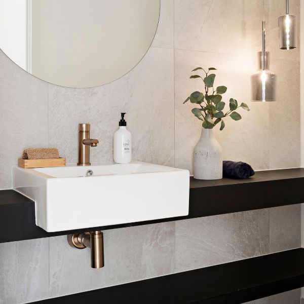 Meir Pinless Round Basin Mixer Champagne finish features bottle trap and round mirror in modern bathroom design - The Blue Space